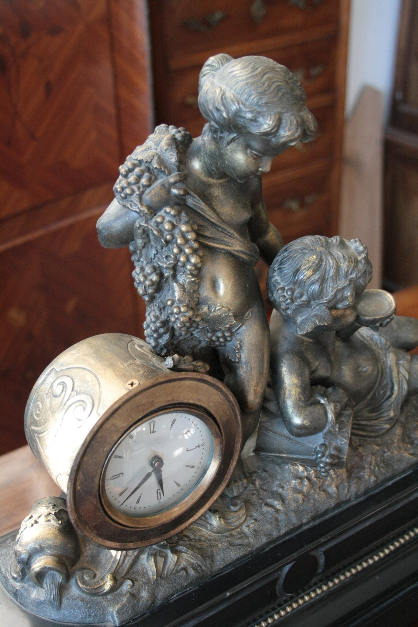 Orologio Napoleone III del XIX secolo in bronzo ottone e marmo con cherubini e uva