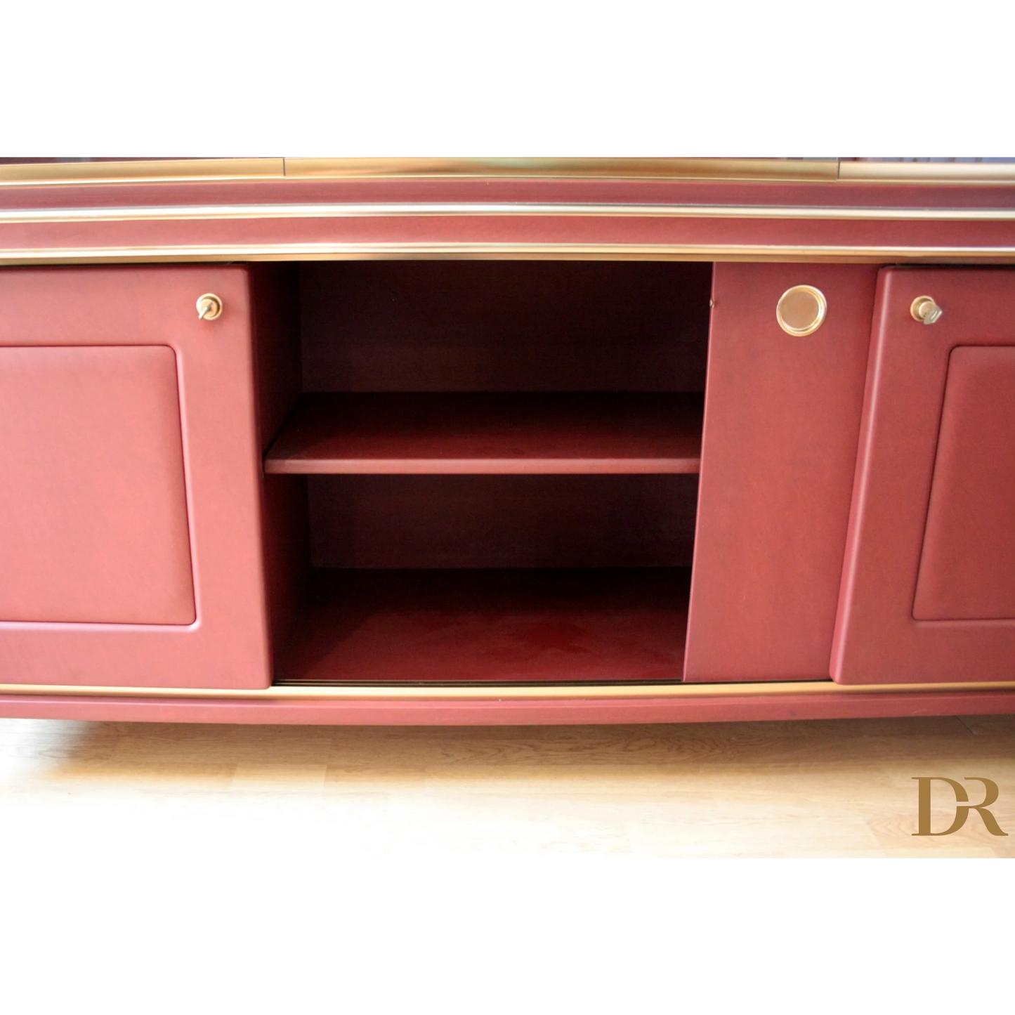 Red cabinet with sliding doors in Set Studio Umberto Mascagni with similpelle bordeaux