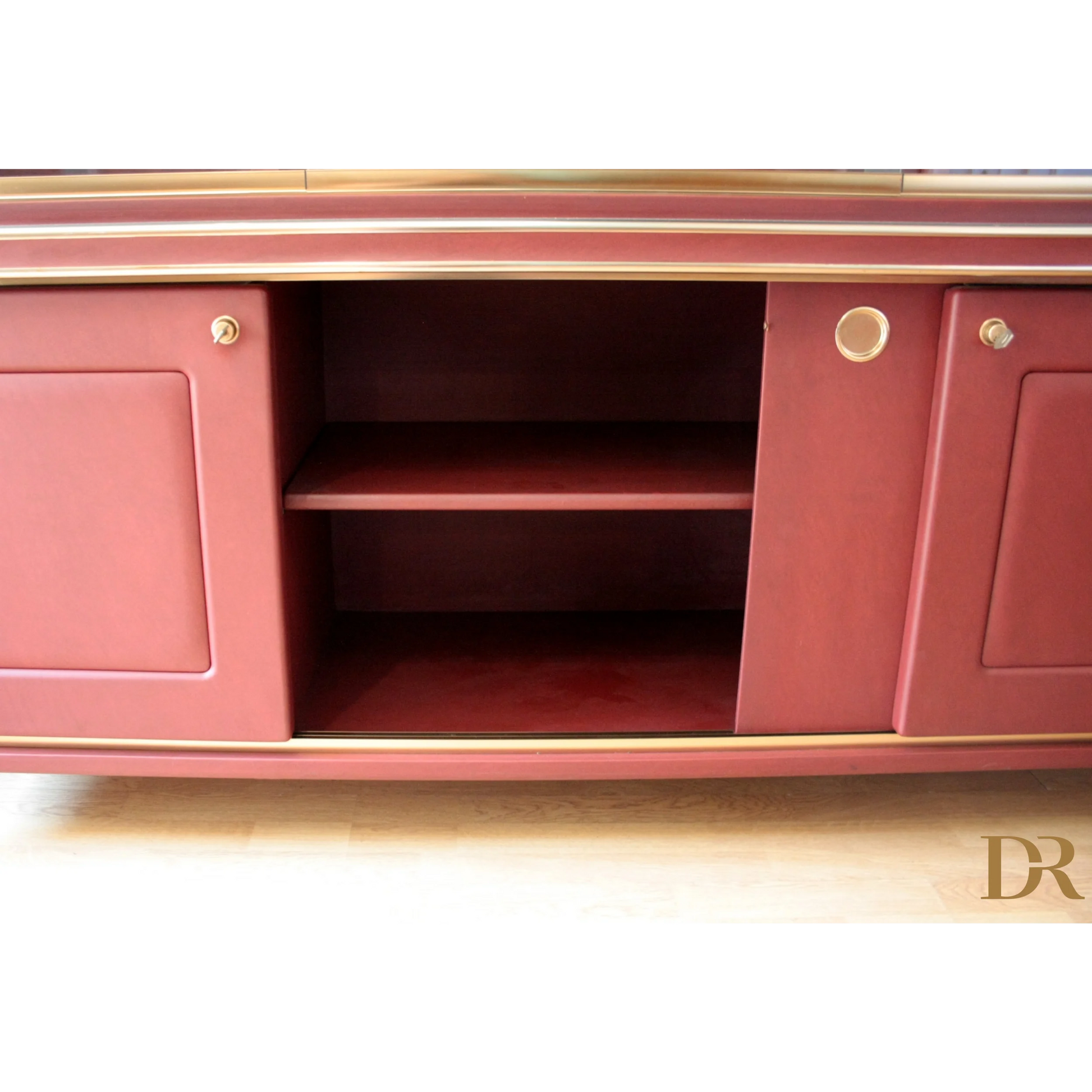 Red cabinet with sliding doors in Set Studio Umberto Mascagni with similpelle bordeaux